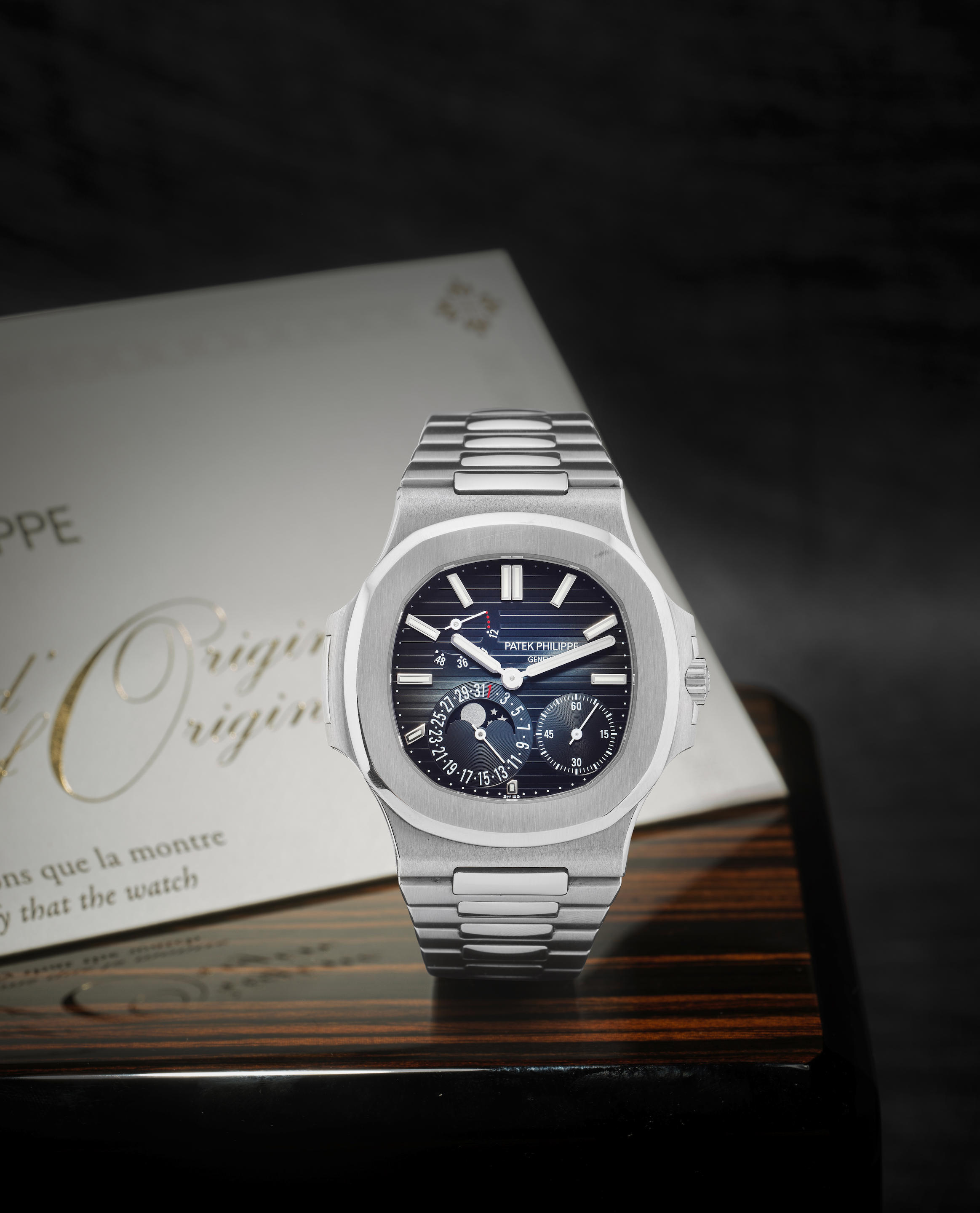Patek Philippe. A fine and rare stainless steel automatic calendar bracelet watch with power reserve and moon phase
