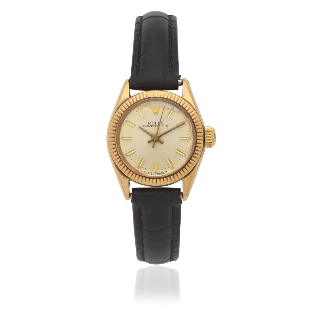 Rolex. A lady's 9K gold automatic calendar wristwatch