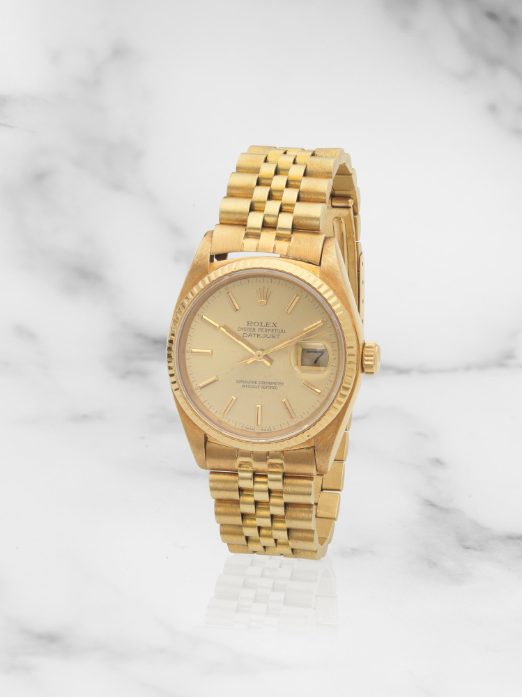 Rolex. An 18K gold automatic calendar bracelet watch