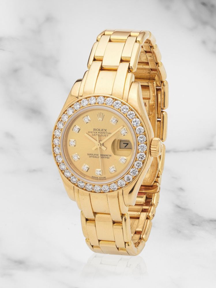 Rolex. A lady's 18K gold and diamond set automatic calendar bracelet watch