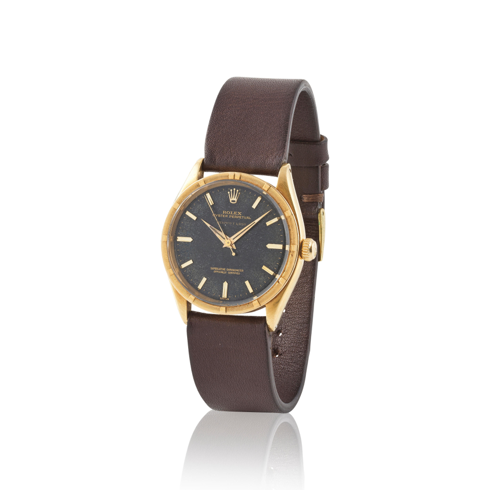 Rolex. An 18K gold automatic wristwatch retailed by Serpico y Laino