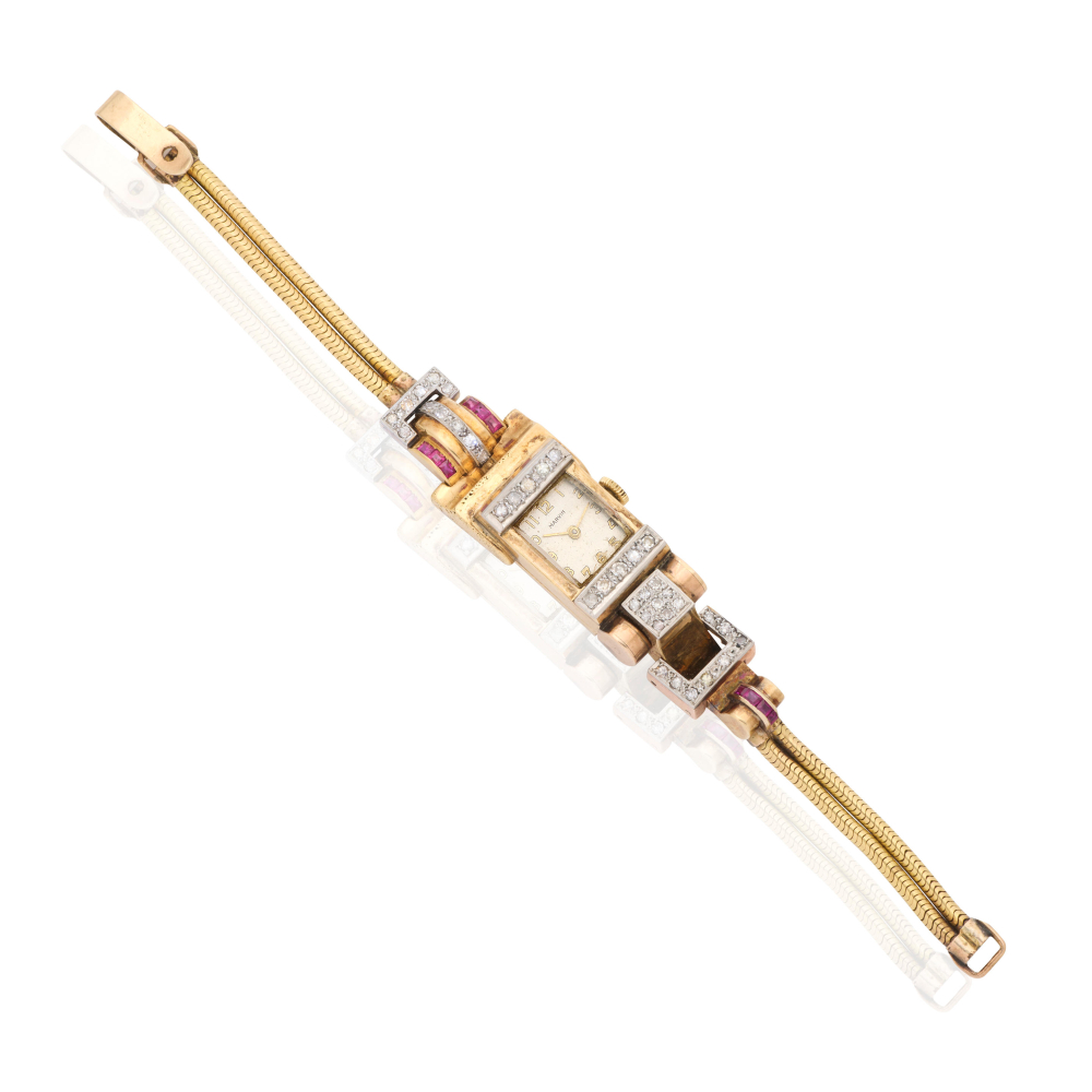 Marvin. A 9K gold diamond and ruby set manual wind bracelet watch with 18K gold bracelet