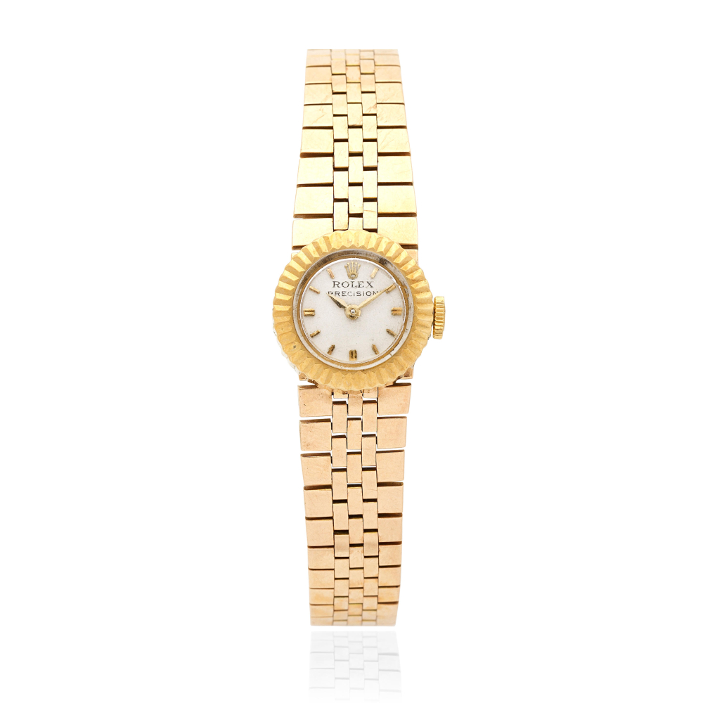 Rolex. A lady's 18K gold manual wind bracelet watch with interchangeable straps