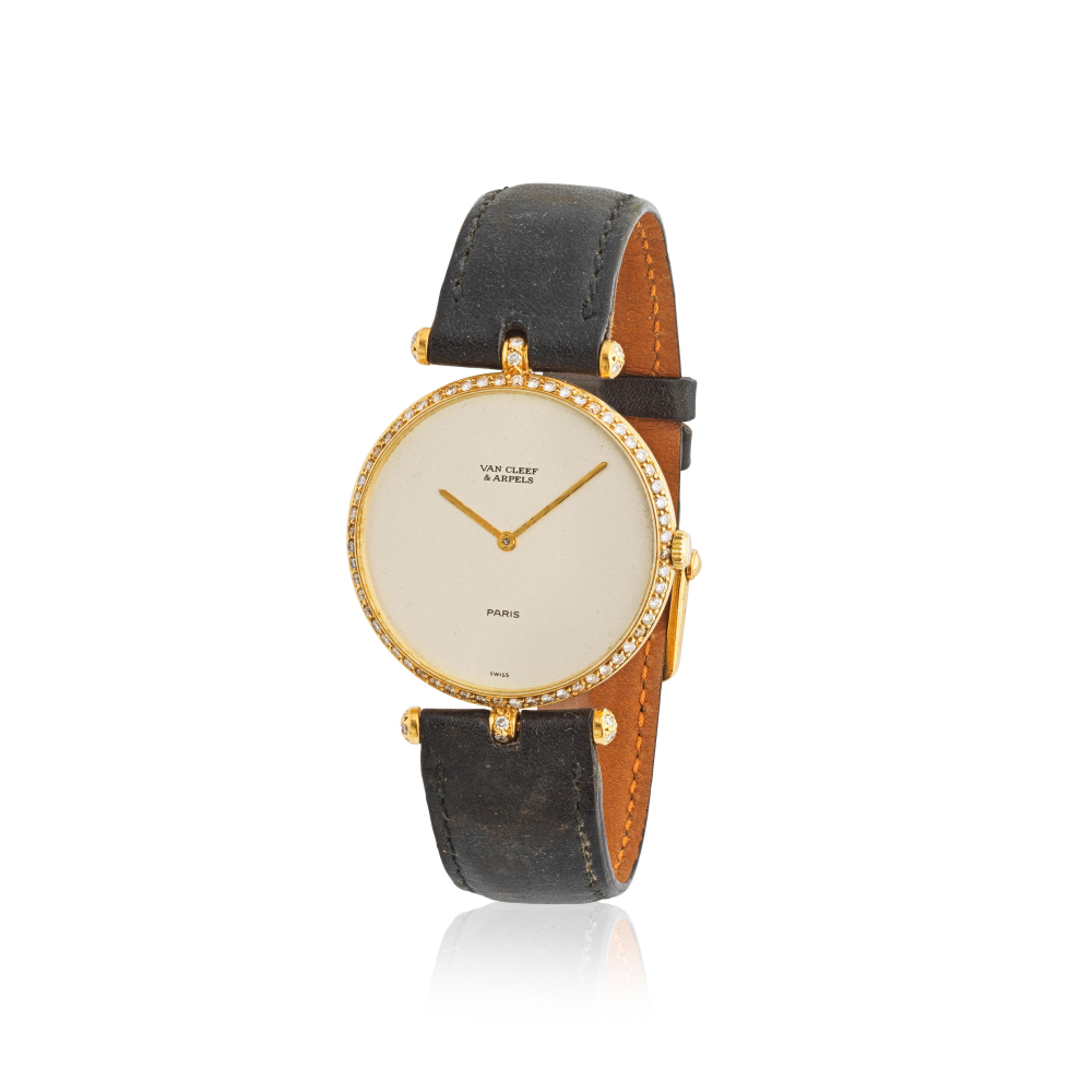 Van Cleef Arpels. A lady's 18K gold manual wind wristwatch with diamond set bezel