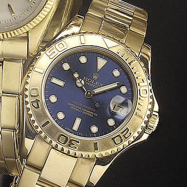 Rolex. An 18ct gold mid-size automatic centre seconds calendar wristwatch