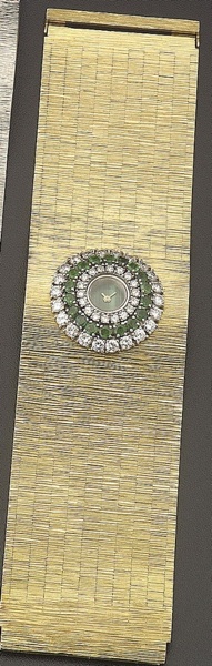 Milner. A ladys diamond and emerald set 18ct gold bracelet watch with malachite dial