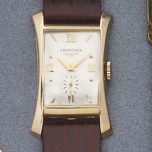 Longines. A 14ct gold hour glass shape rectangular wristwatch
