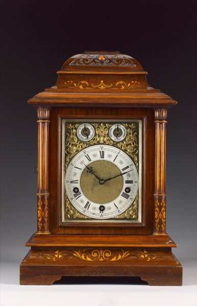 An early 20th century German boxwook inlaid mahogany quarter chimng mantel clock