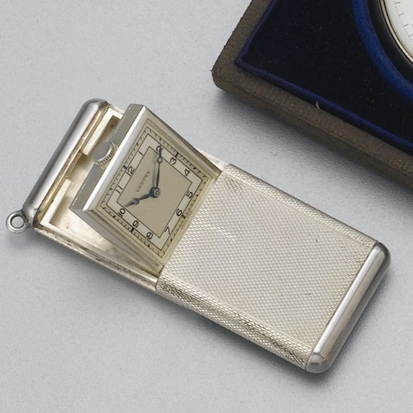 Vertex. A silver engine turned bag watch