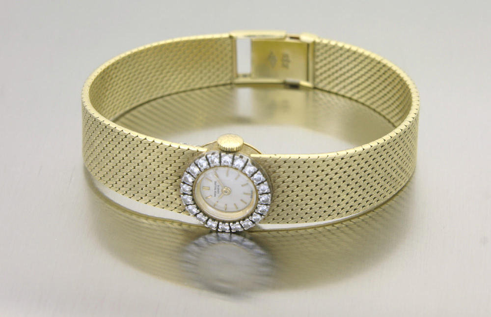 Patek Philippe. A lady's 18ct gold bracelet watch with diamond set bezel