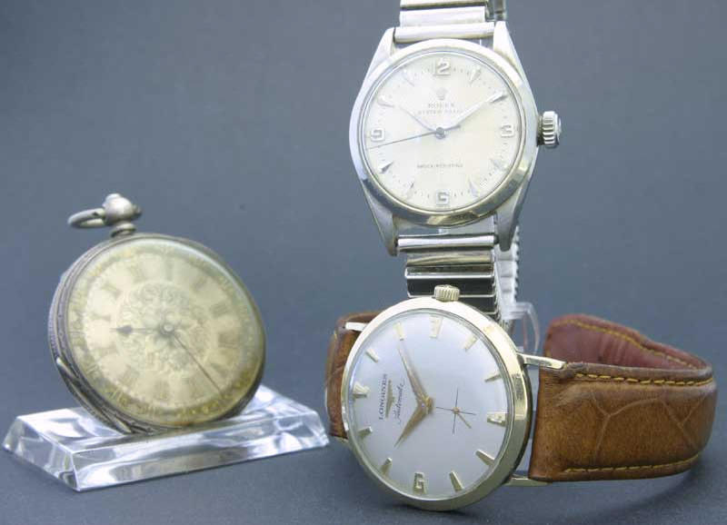 Rolex. A mid size steel wristwatch with a Longines wristwatch and an unsigned fob watch