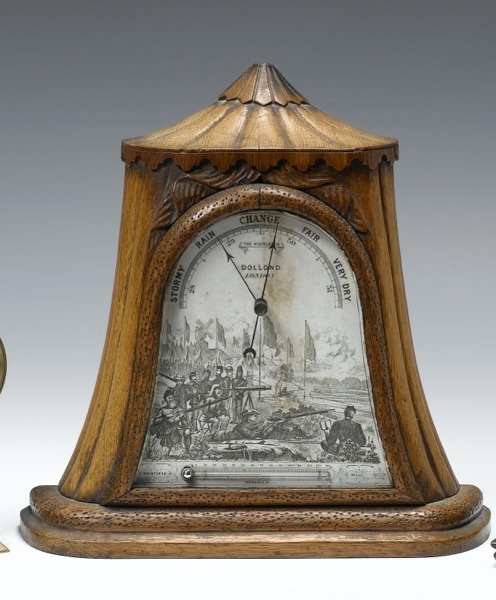A rare second half of the 19th century carved oak table aneroid barometer possibly depicting Queen Victoria and her gillie John Brown
