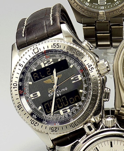 Breitling. A stainless steel dual display chronograph watch with papers