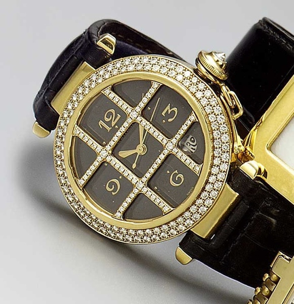 Cartier. An 18ct gold and diamond set automatic calendar wristwatch