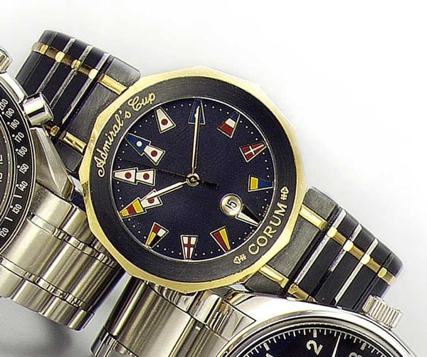 Corum. A blued steel and gold quartz calendar bracelet watch