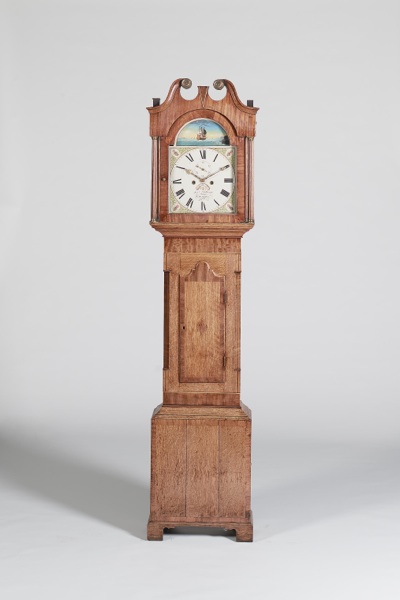 An early 19th century oak and mahogany longcase clock
