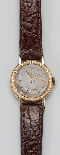 Rolex. A lady's 18ct gold wristwatch with rare star dial