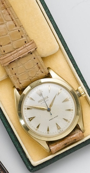Rolex. A 10ct gold manual wind wristwatch with original box