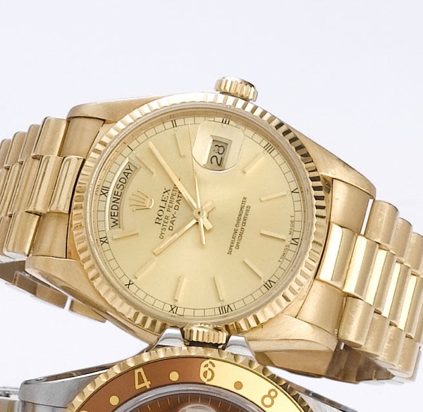 Rolex. An 18ct gold automatic calendar bracelet watch with factory box