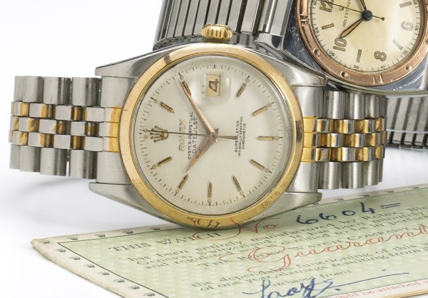 Rolex. A stainless steel and gold self-winding calendar wristwatch on associated bracelet