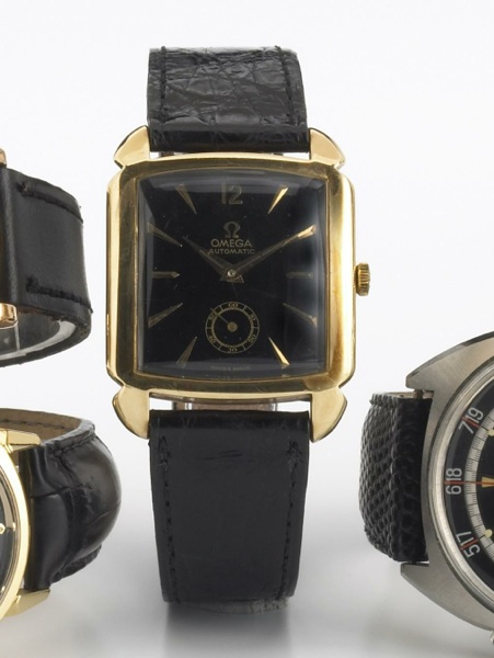 Omega. A 14k gold square cased self-winding wristwatch with black dial