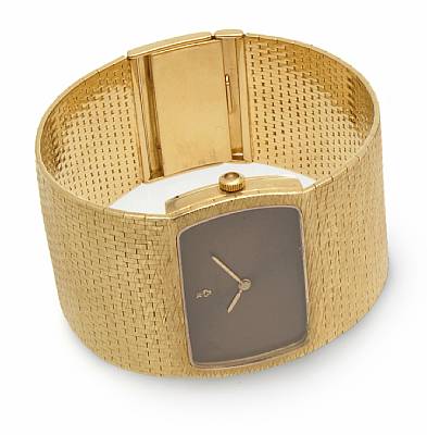 Corum. An unusual 18k gold wide bracelet watch