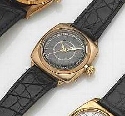 Rolex. A 9k gold cushion shape wristwatch with black dial and center seconds