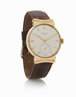 Patek Philippe. A fine and rare 18k rose gold wristwatch with covered scroll lugs
