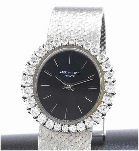 Patek Philippe. A fine lady's 18ct white gold diamond set bracelet watch with fitted box