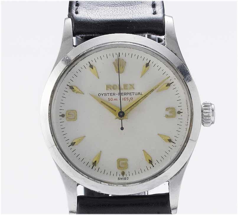 Rolex. A stainless steel centre seconds automatic wristwatch with red text