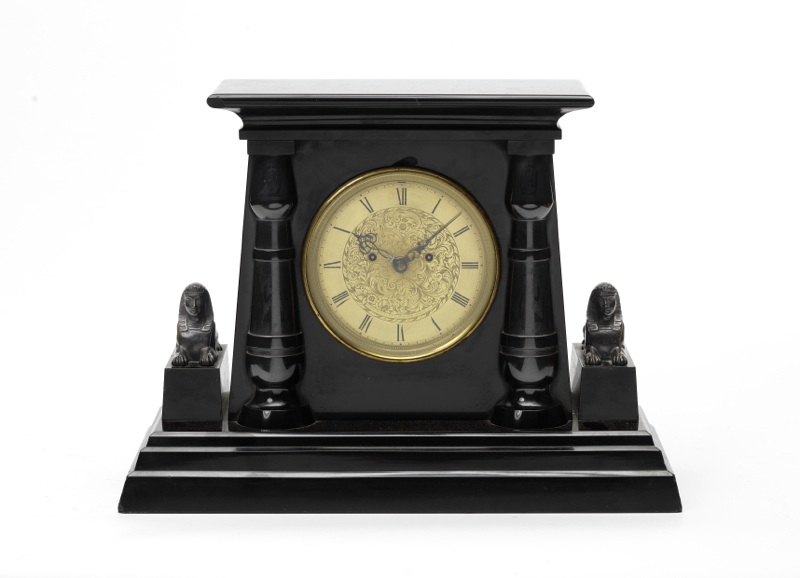 A polished slate mantel clock