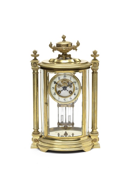 A late 19th century French ornate oval four-glass mantel clock