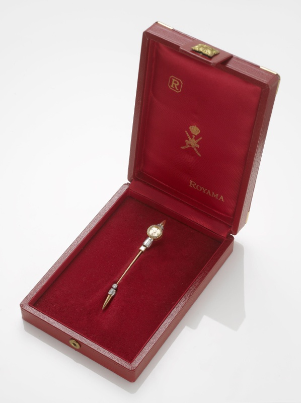 Royama. A stainless steel and gold diamond set jabot pin containing a watch with fitted box