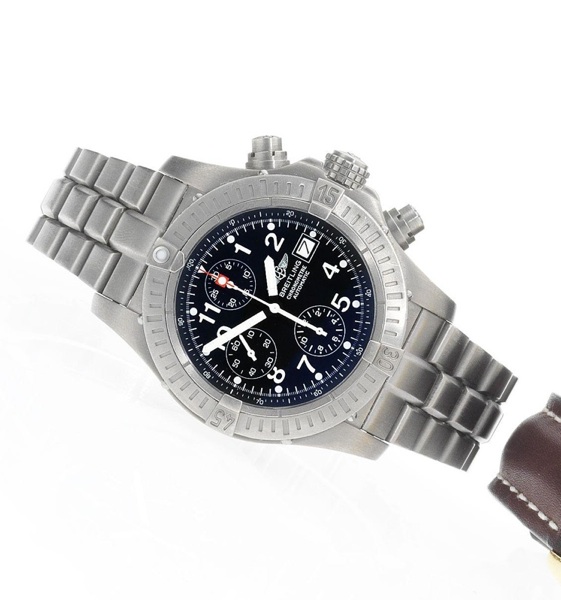 Breitling. A titanium automatic calendar chronograph bracelet watch together with fitted box papers