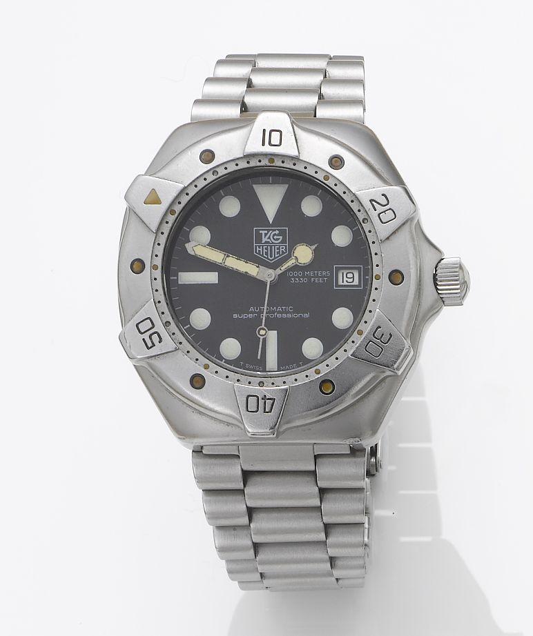 Tag Heuer. A stainless steel automatic centre seconds calendar bracelet watch