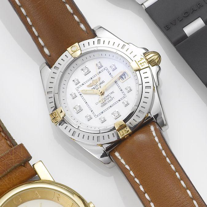 Breitling. A lady's stainless steel and gold diamond set centre seconds calendar wristwatch together with fitted box and papers