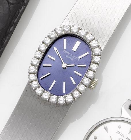Patek Philippe. A lady's 18ct white gold diamond set bracelet watch together with fitted box