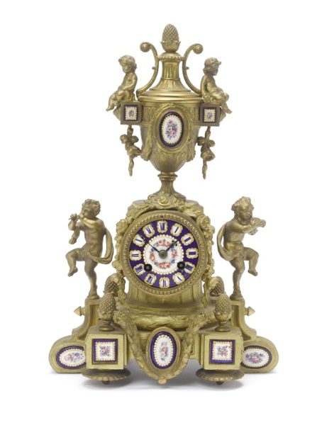 A late 19th century French gilt panelled mantel clock and a leather cased travel clock