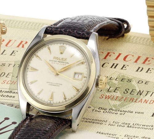 Rolex. A fine and rare stainless steel and gold, automatic centre seconds calendar wristwatch together with original chronometer service papers