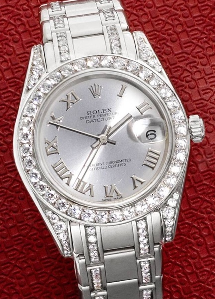 Rolex. A mid-sized 18ct white gold and diamond set automatic calendar bracelet watch together with Rolex box and papers