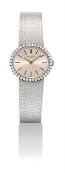 PATEK PHILIPPE. A LADY'S FINE 18K WHITE GOLD AND DIAMOND-SET OVAL BRACELET WATCH
