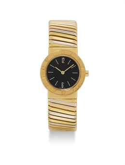 BULGARI. A LADY'S 18K THREE-COLOUR GOLD BANGLE WATCH