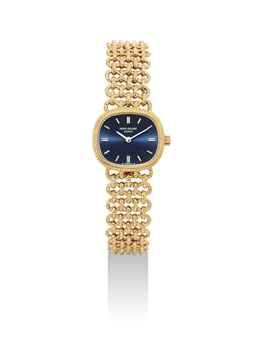 PATEK PHILIPPE. A LADY'S FINE 18K GOLD CUSHION-SHAPED BRACELET WATCH