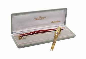 ROLEX. A LADY'S UNUSUAL 18K GOLD OVAL WRISTWATCH WITH BRACELET AND ORIGINAL BOX