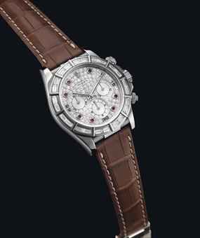 ROLEX. A FINE 18K WHITE GOLD, RUBY AND DIAMOND-SET AUTOMATIC CHRONOGRAPH WRISTWATCH