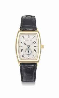 Breguet. An 18K gold tonneau-shaped curved automatic wristwatch