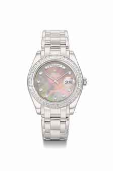 Rolex. An extremely fine and heavy platinum and diamond-set automatic wristwatch with sweep centre seconds, day, date, mother-of-pearl dial and bracelet