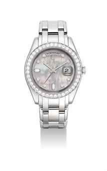 ROLEX. A FINE AND RARE PLATINUM AND DIAMOND-SET AUTOMATIC WRISTWATCH WITH SWEEP CENTRE SECONDS, DAY, DATE, BRACELET AND MOTHER-OF-PEARL DIAL