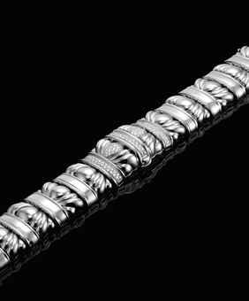 PATEK PHILIPPE. A LADY ’ S ELEGANT AND UNUSUAL 18K WHITE GOLD AND DIAMOND-SET RECTANGULAR BRACELET WATCH WITH CONCEALED DIAL