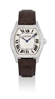 CARTIER. A FINE 18K WHITE GOLD AND DIAMOND-SET TONNEAU-SHAPED WRISTWATCH